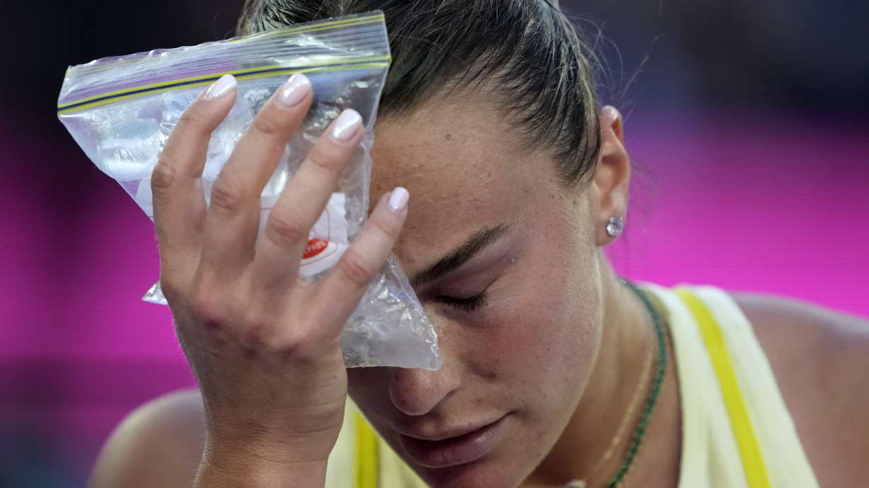 Aryna Sabalenka of Belarus places a bag of ice to her face during the women's singles final against Madison Keys of the U.S. at the Australian Open tennis championship in Melbourne, Australia, Saturday, Jan. 25, 2025.