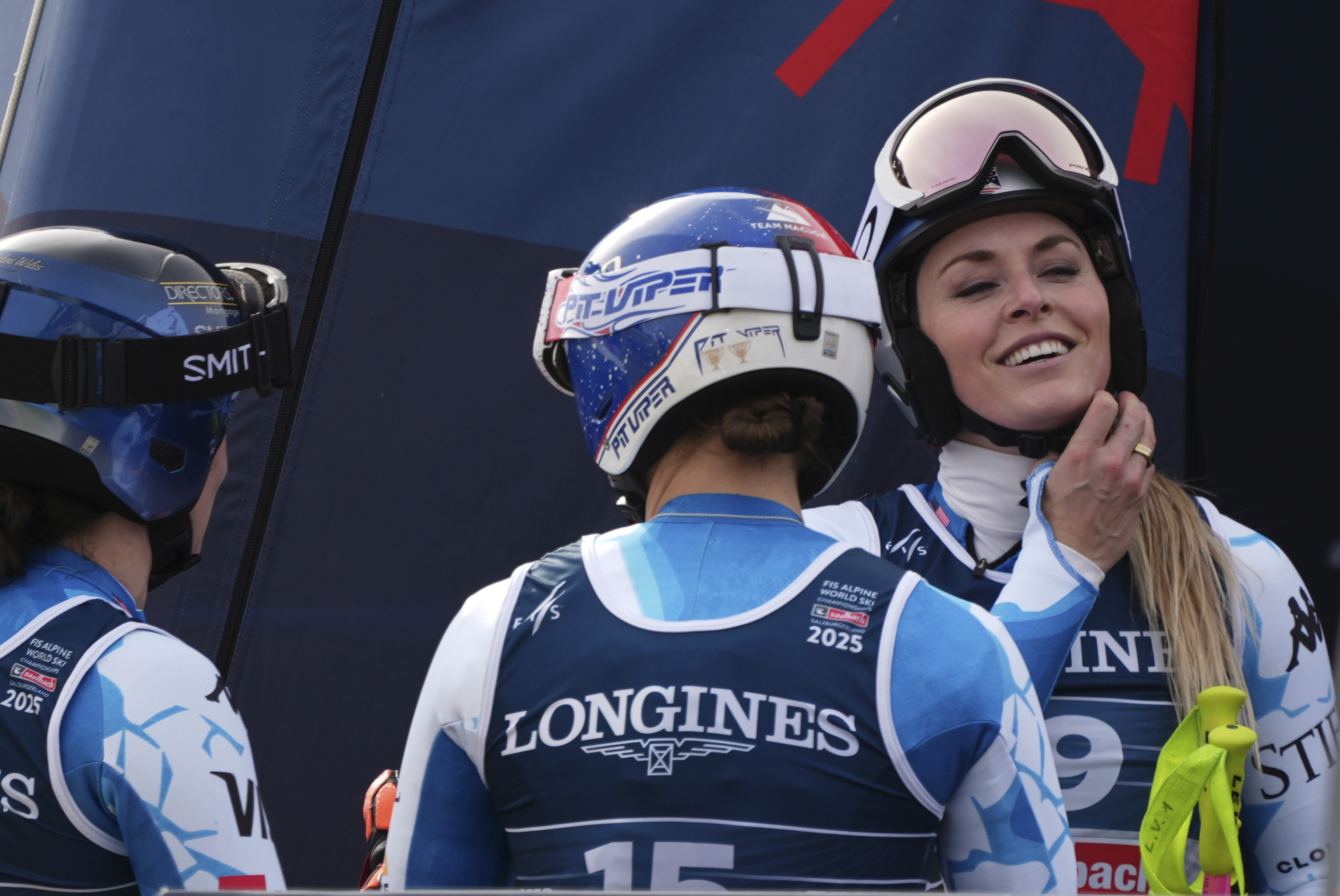 United States' Lindsey Vonn, right, talks to United States' Lauren Macuga, center, and United States' Jacqueline Wiles, right, at the finish area of a downhill run of a women's team combined event, at the Alpine Ski World Championships, in Saalbach-Hinterglemm, Austria, Tuesday, Feb. 11, 2025.