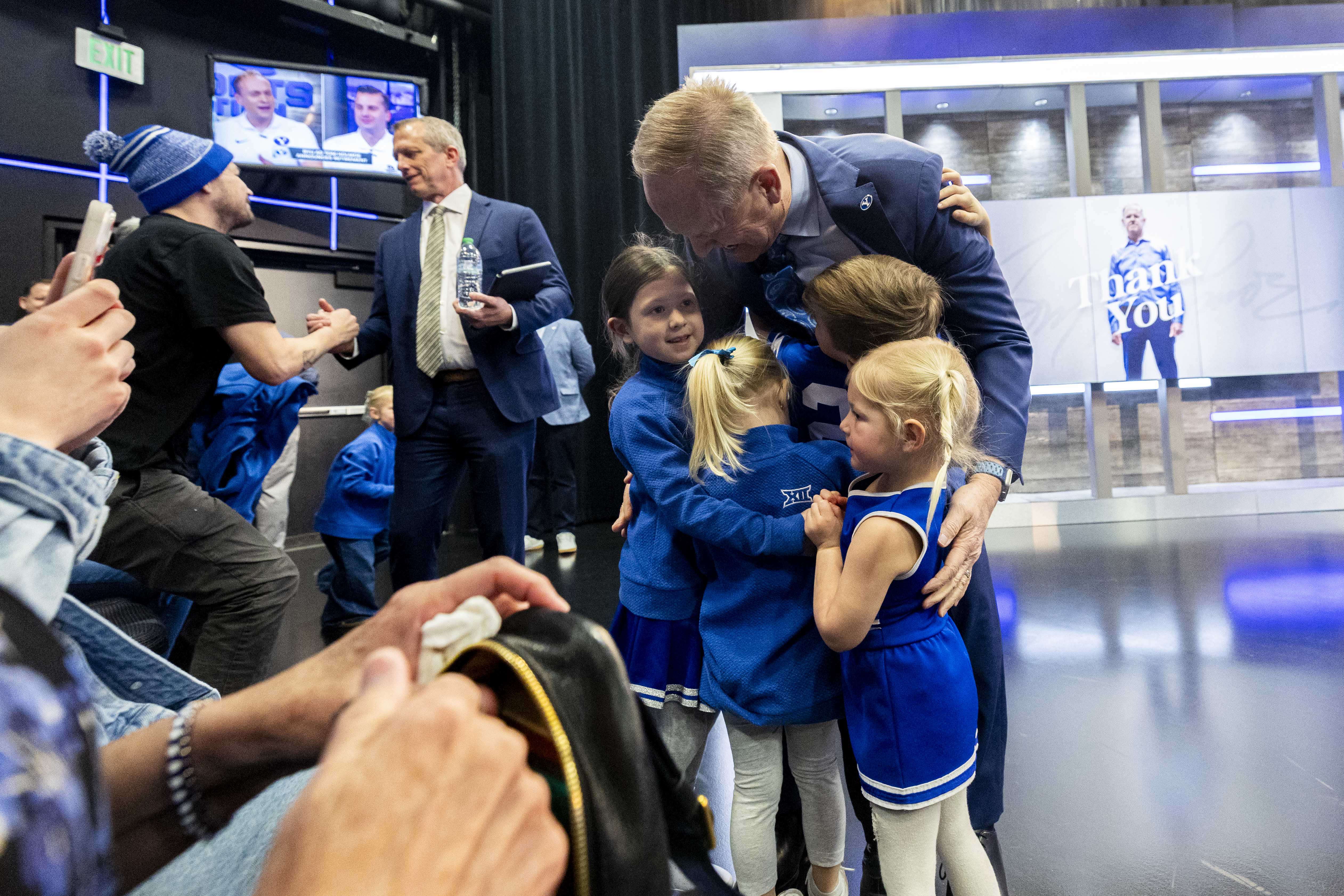 Brigham Young University athletic director Tom Holmoe hugs his grandchildren after a press conference announcing his retirement at the end of the school year held at the BYU Broadcast Building on the university’s campus in Provo on Wednesday, Feb. 12, 2025.