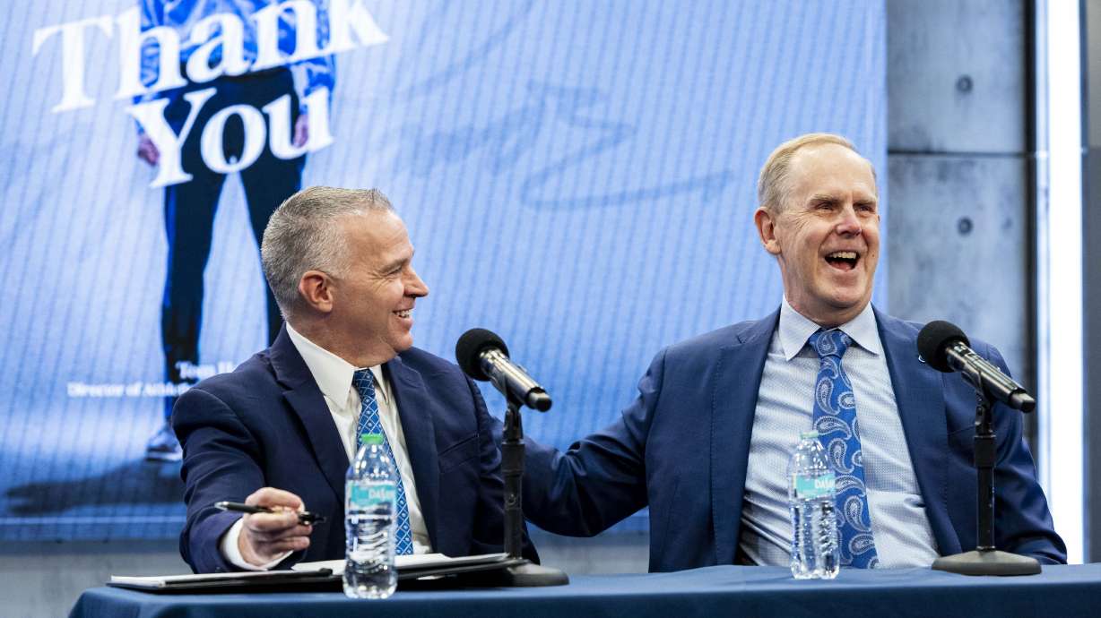 Brigham Young University Athletic Director Tom Holmoe jokes with BYU President C. Shane Reese during a press conference announcing his retirement at the end of the school year held at the BYU Broadcast Building on the university’s campus in Provo on Wednesday, Feb. 12, 2025.