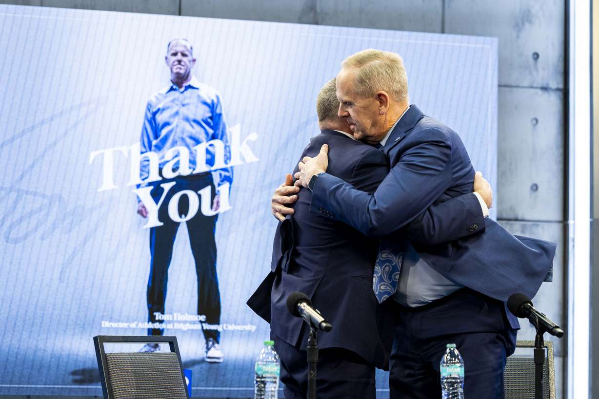 Brigham Young University Athletic Director Tom Holmoe hugs BYU President C. Shane Reese at the end of a press conference announcing Holmoe’s retirement at the end of the school year held at the BYU Broadcast Building on the university’s campus in Provo on Wednesday, Feb. 12, 2025.
