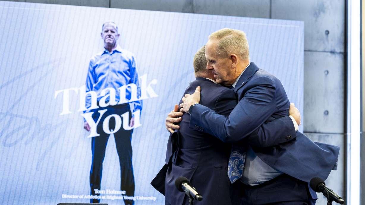 Brigham Young University Athletic Director Tom Holmoe hugs BYU President C. Shane Reese at the end of a press conference announcing Holmoe’s retirement at the end of the school year held at the BYU Broadcast Building on the university’s campus in Provo on Wednesday, Feb. 12, 2025.