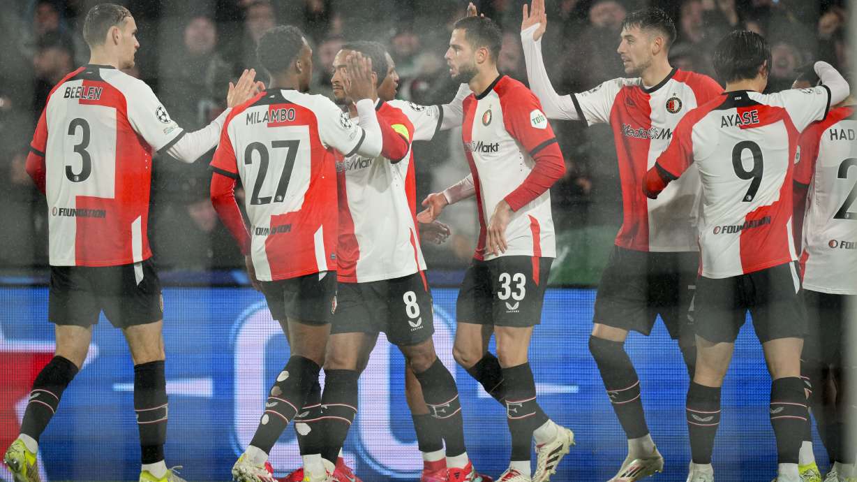 Feyenoord's players celebrate their opening goal, scored by Igor Paixao during the Champions League playoff first leg soccer match between Feyenoord and AC Milan, at the De Kuip stadium, in Rotterdam, Netherlands, Wednesday, Feb. 12, 2025.