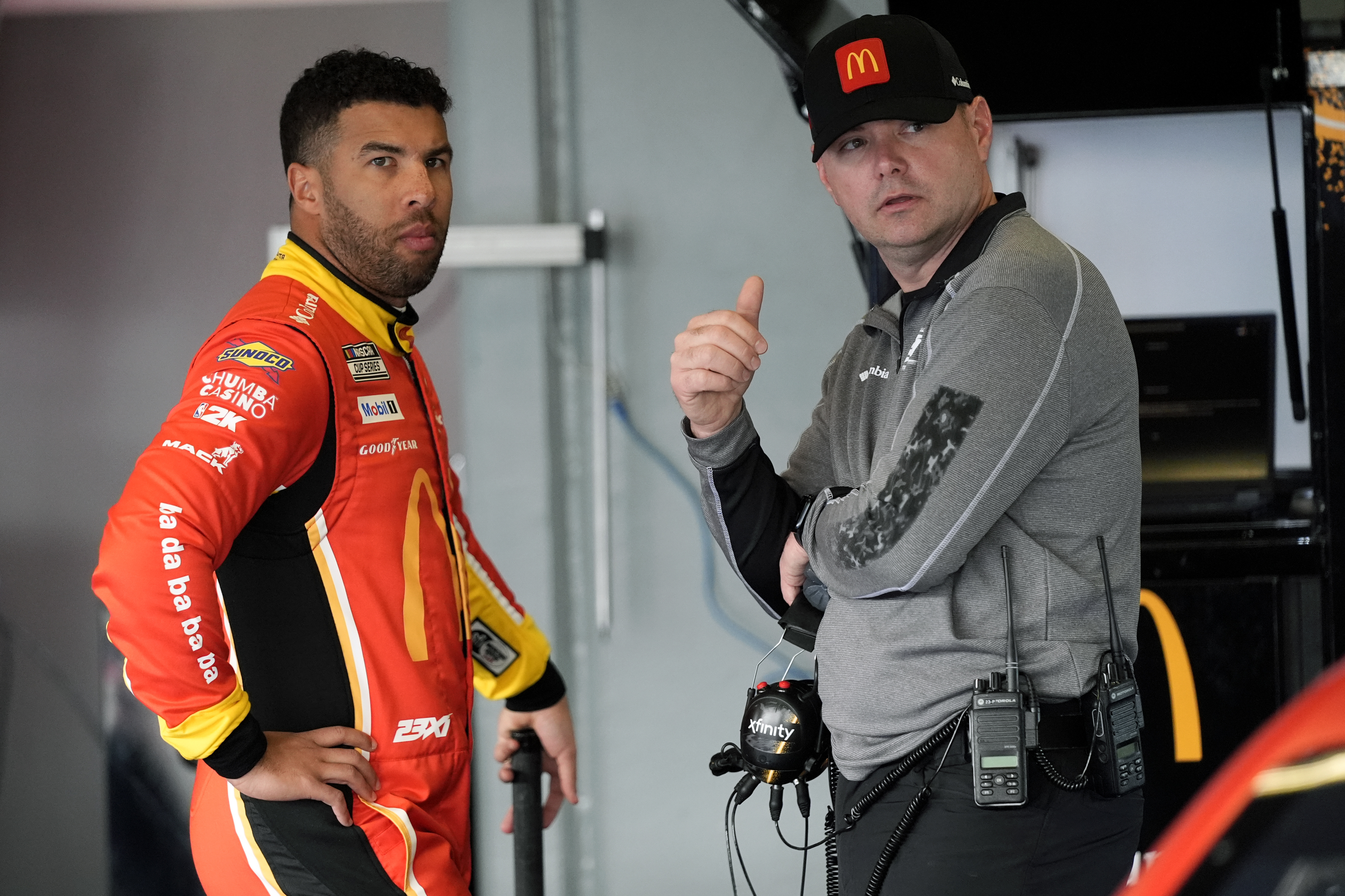 Bubba Wallace, left, talks with his crew chief Charles Denise in the garage during practice for the NASCAR Daytona 500 auto race at Daytona International Speedway, Wednesday, Feb. 12, 2025, in Daytona Beach, Fla.