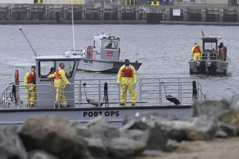 U.S. Navy boats work along the shore near Shelter Island after a U.S. Navy plane crashed into the San Diego Bay, Calif., Wednesday.