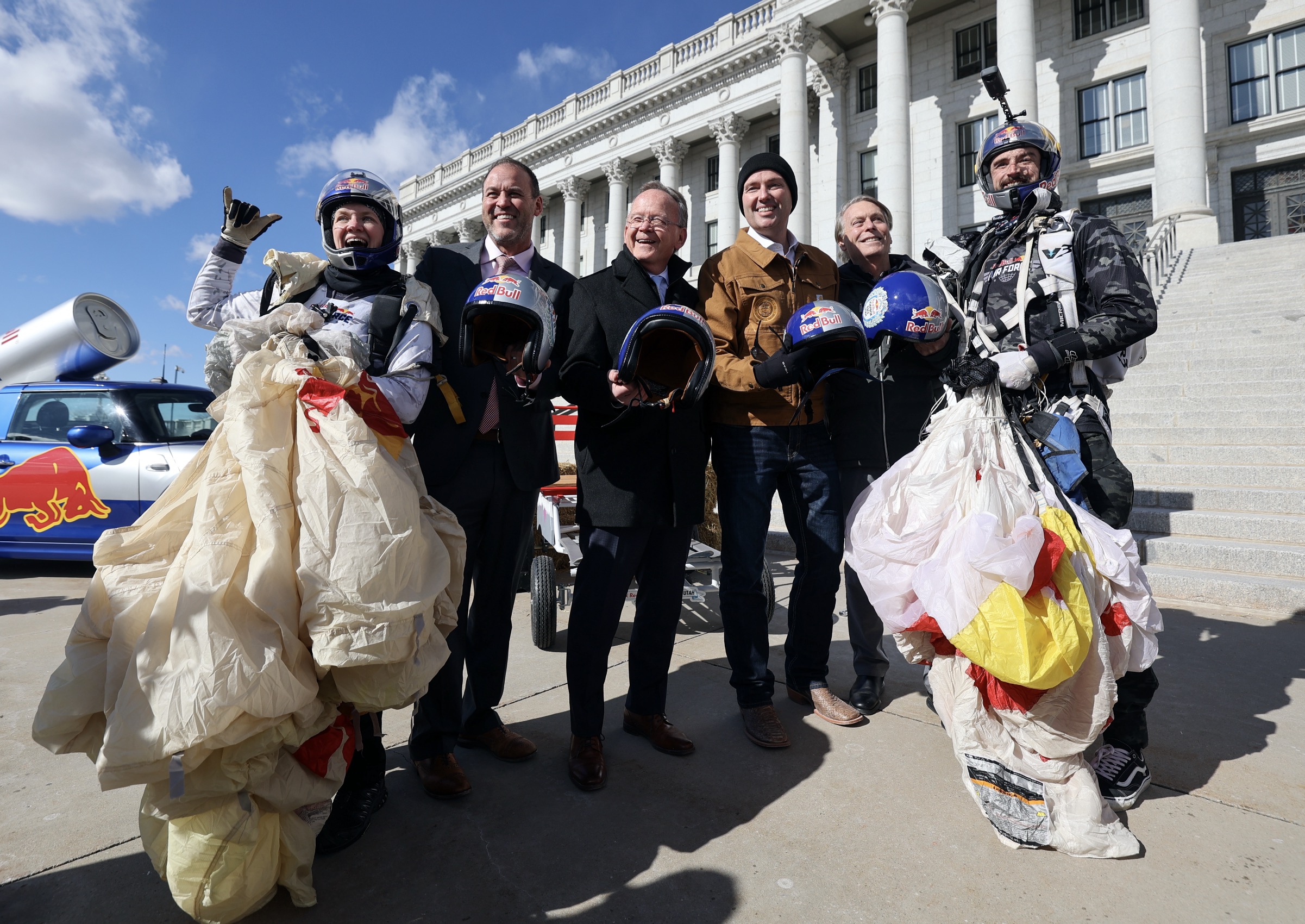 Utah government and sports leaders pose for a photo with Red Bull Air Force skydivers at a press conference to announce the debut of the Red Bull Soapbox Race Utah at the Capitol in Salt Lake City on Wednesday. The race will take place on June 14.