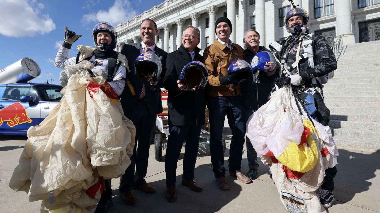 Utah government and sports leaders pose for a photo with Red Bull Air Force skydivers at a press conference to announce the debut of the Red Bull Soapbox Race Utah at the Capitol in Salt Lake City on Wednesday. The race will take place on June 14.