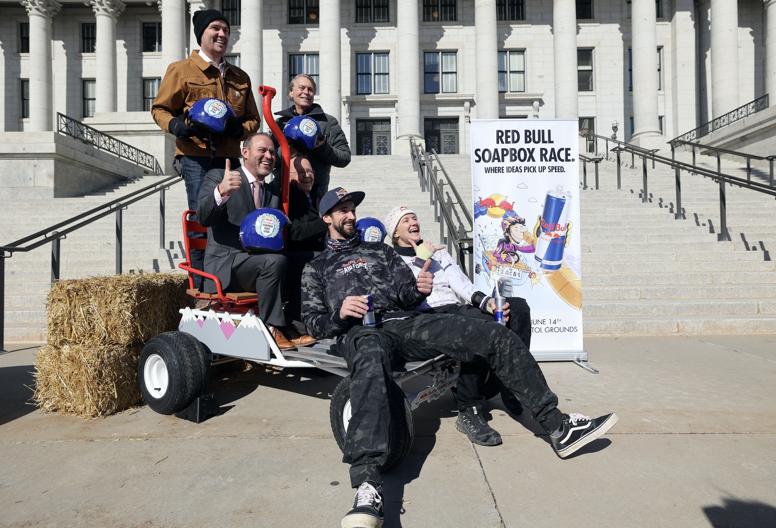 Governor Spencer Cox; Mike Mike Schultz House; Senate President Stewart Adams; Jeff Robins, Chairman and Executive Director of the Sports Committee Commission in Utah; Skydiver on Red Bull Skydiver Mike Brewer and Red Bull Skydiver Skydiver Amy Chmelecki poses for a photo of a soap car during a press conference to announce the debut of Red Bull SOAPBOX Race UTAH The competition will be held in Capitol on June 14th.