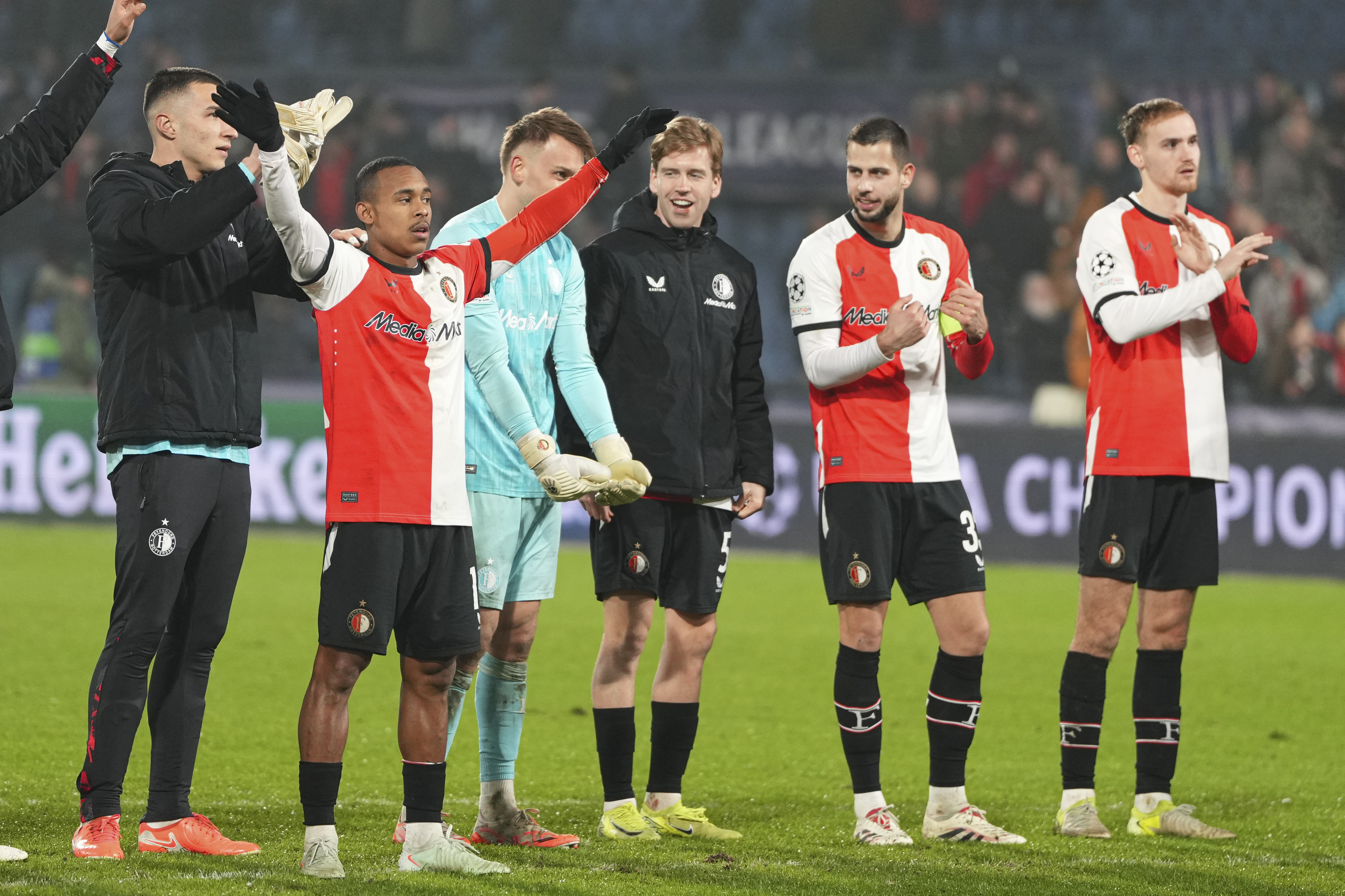 Feyenoord's Igor Paixao, left, and team mates salute fans after the the Champions League playoff first leg soccer match between Feyenoord and AC Milan, at the De Kuip stadium, in Rotterdam, Netherlands, Wednesday, Feb. 12, 2025.