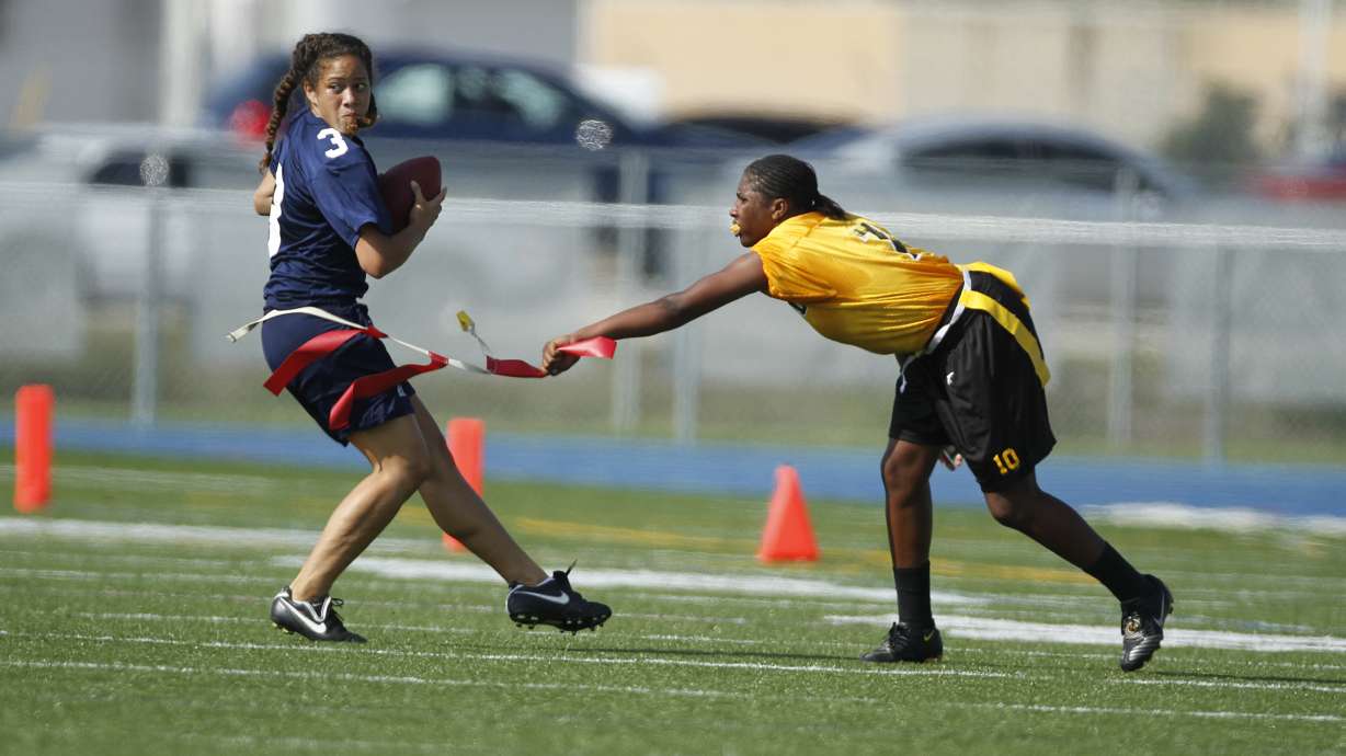 FILE - Lakewood's Paige Johnson pulls the flag off Alonso's Sarah Peterika during a quarterfinal in the state high school flag football tournament in Boca Raton, Fla., May 7, 2010.
