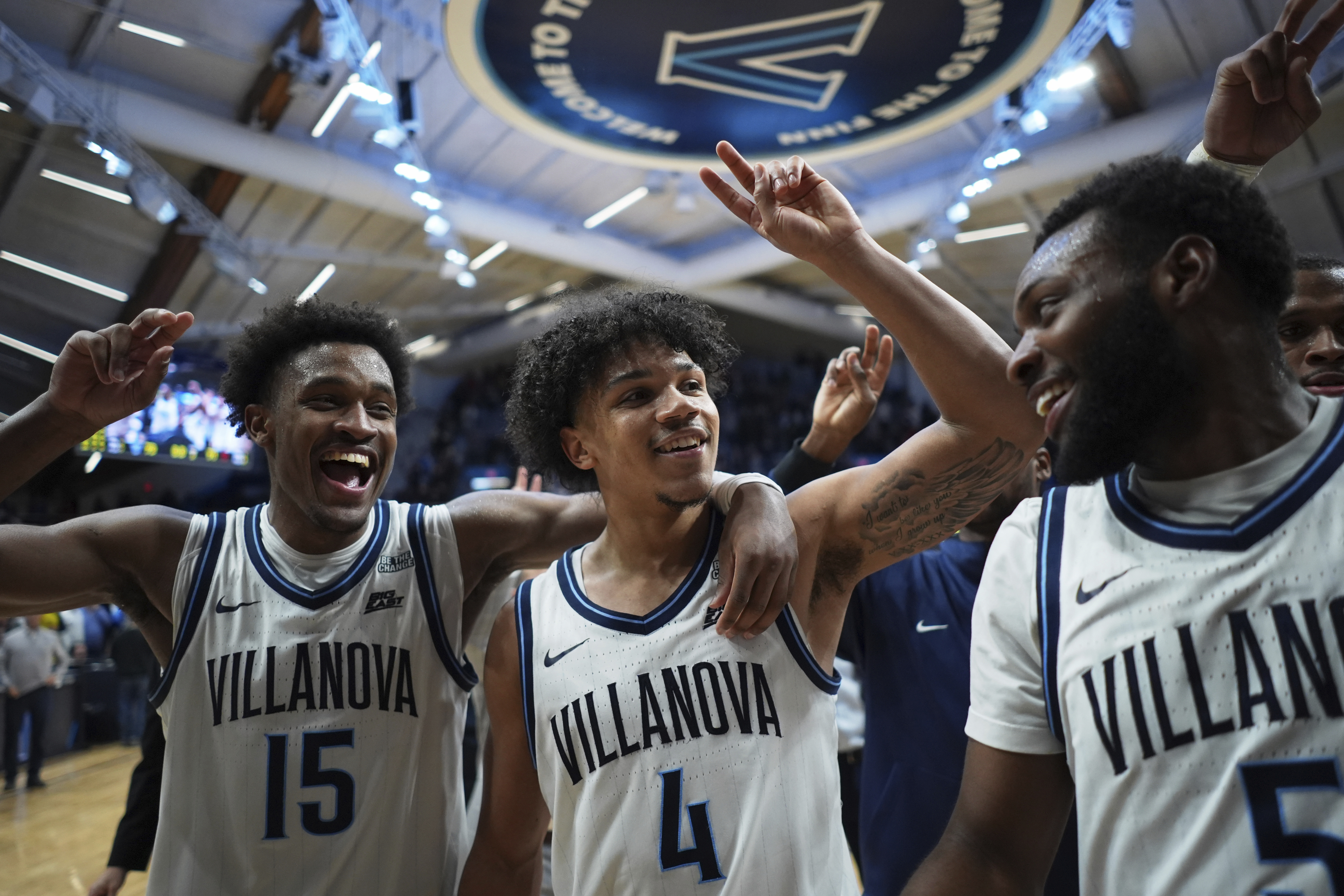 Villanova's Jordan Longino, from left, Tyler Perkins and Wooga Poplar celebrate after Villanova won an NCAA college basketball game against St. John's, Wednesday, Feb. 12, 2025, in Villanova, Pa.