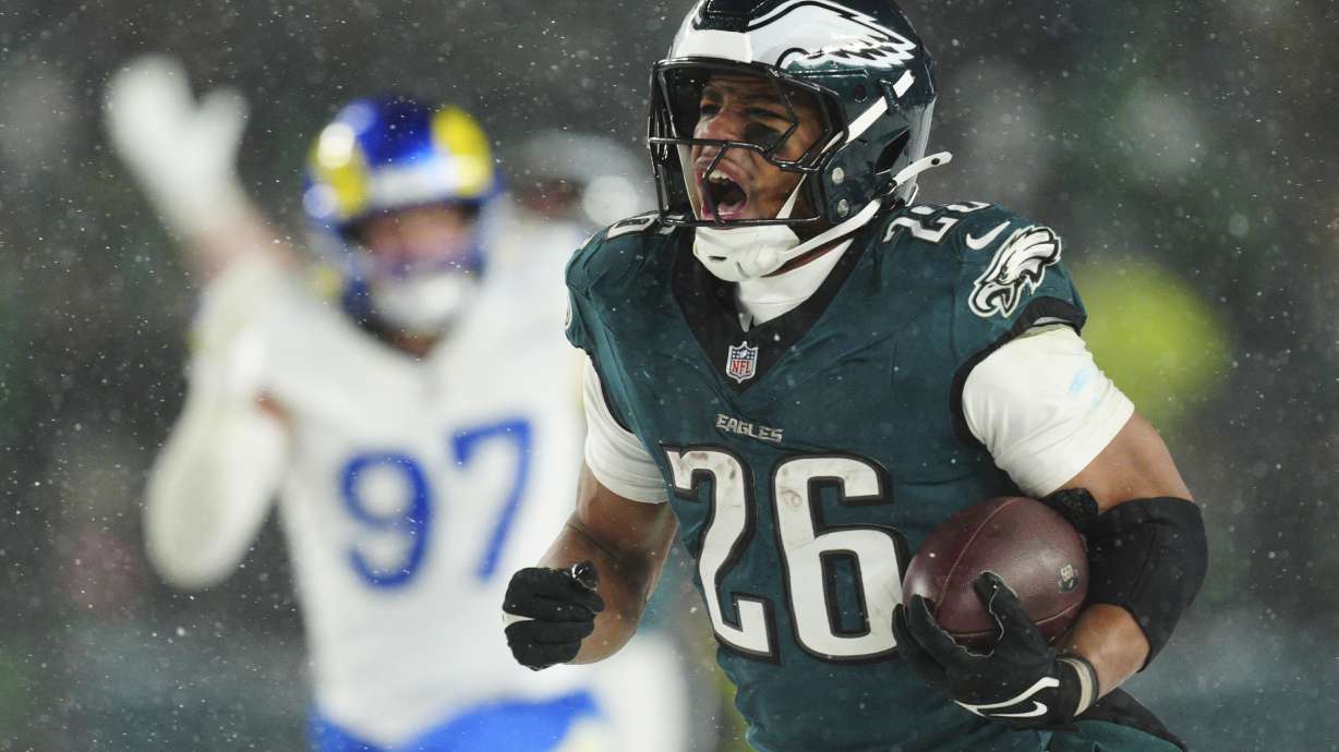 FILE - Philadelphia Eagles running back Saquon Barkley (26) runs the ball for a touchdown during the second half of an NFL football NFC divisional playoff game against the Los Angeles Rams on Sunday, Jan. 19, 2025, in Philadelphia.