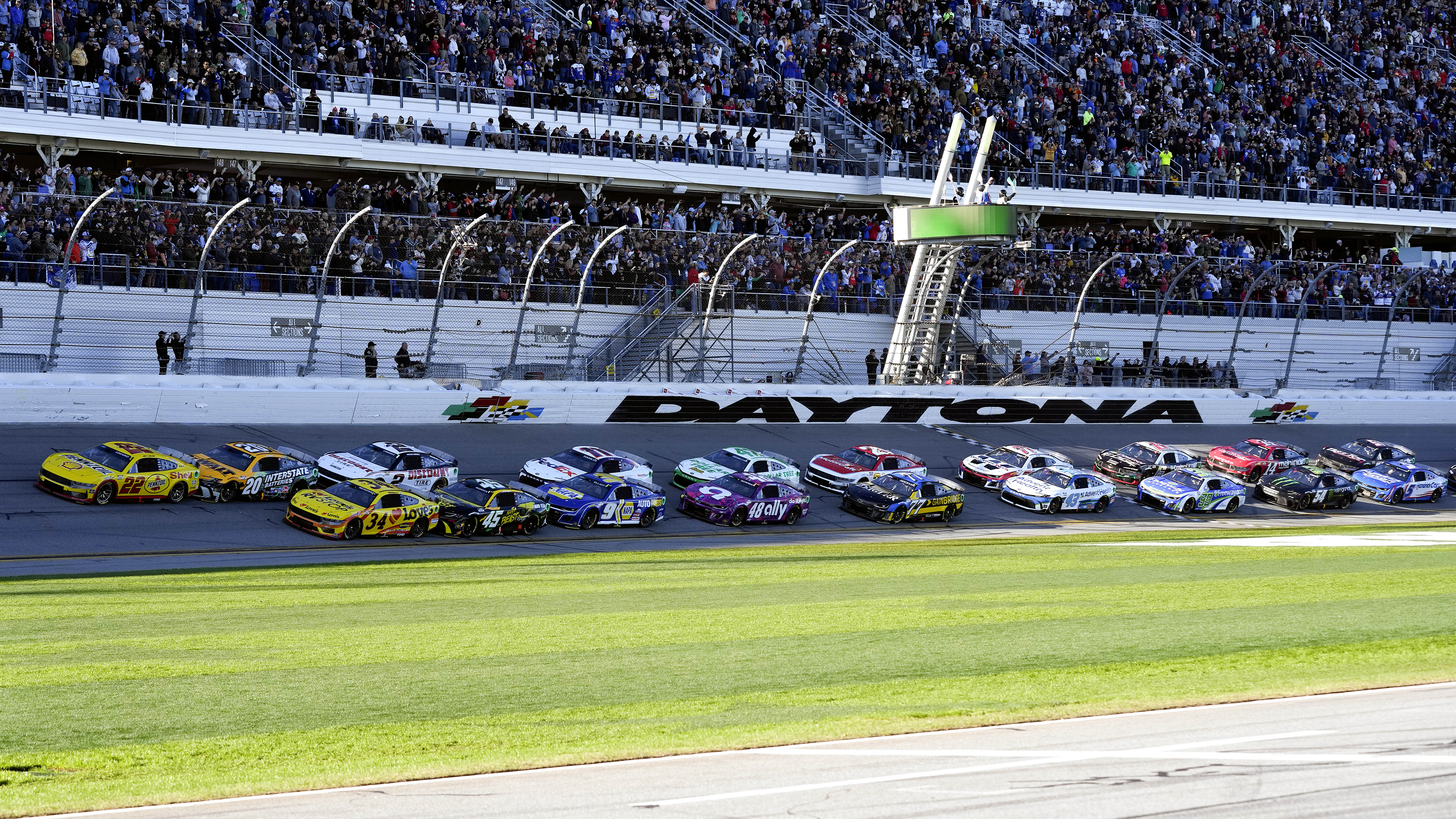FILE - Joey Logano (22) and Michael McDowell (34) lead the field to start the NASCAR Daytona 500 auto race at Daytona International Speedway, Feb. 19, 2024, in Daytona Beach, Fla.