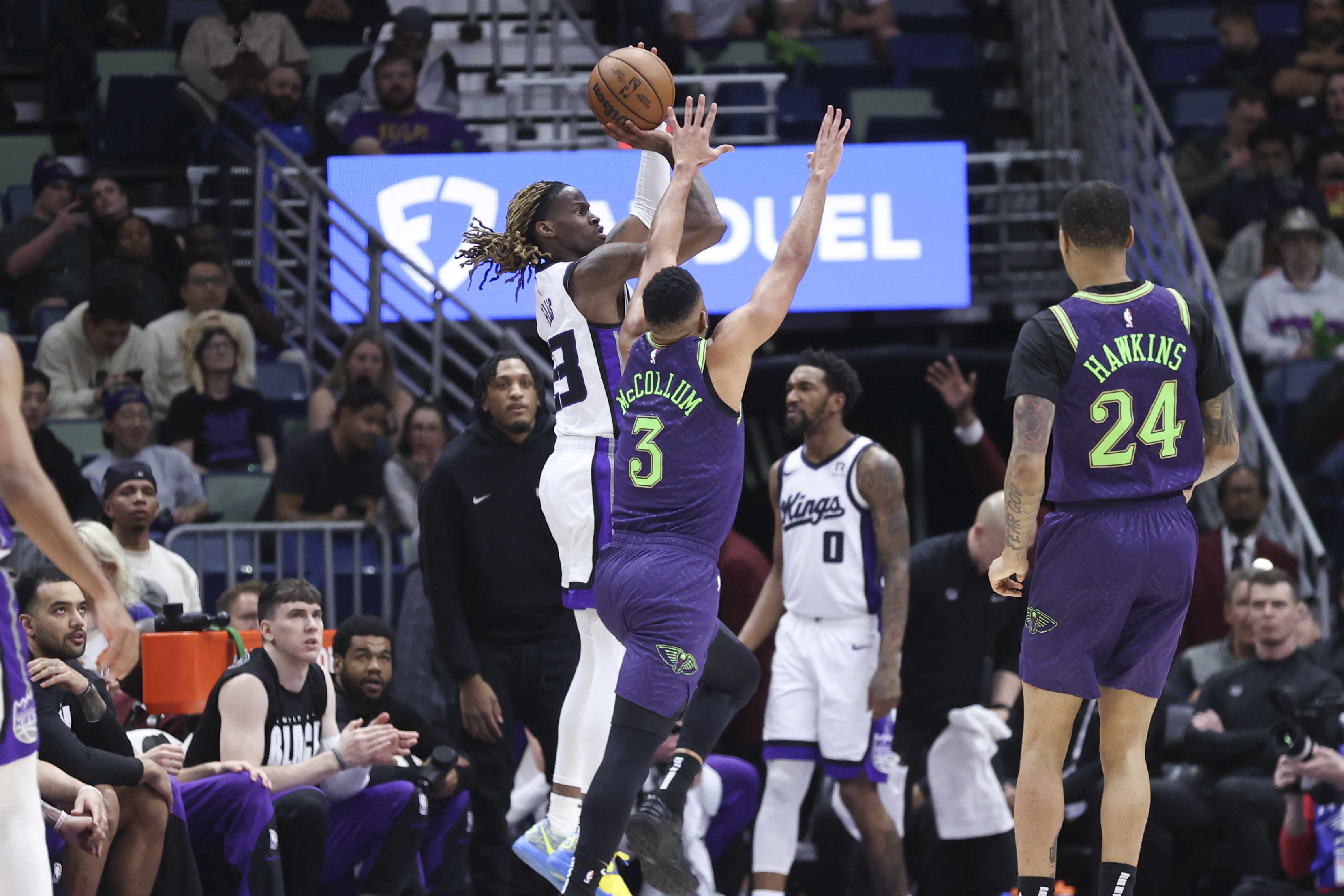 Sacramento Kings guard Keon Ellis (23) shoots a three-pointer over New Orleans Pelicans guard CJ McCollum (3) during the first half of an NBA basketball game in New Orleans, Wednesday, Feb. 12, 2025.