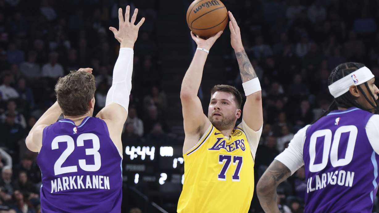 Los Angeles Lakers guard Luka Doncic (77) shoots over Utah Jazz forward Lauri Markkanen (23) and guard Jordan Clarkson (00) during the first quarter of an NBA basketball game, Wednesday, Feb. 12, 2025, in Salt Lake City.