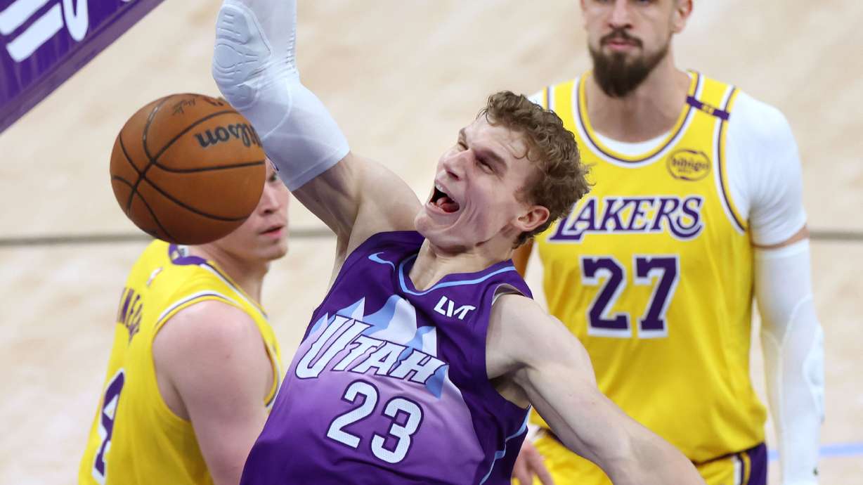 Utah Jazz forward Lauri Markkanen (23) dunks the ball against Los Angeles Lakers guard Dalton Knecht (4) and Alex Len at the Delta Center in Salt Lake City on Wednesday, Feb. 12, 2025.