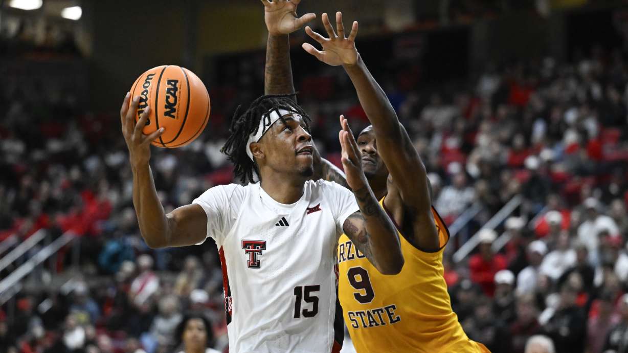 Texas Tech forward JT Toppin (15) attempts to shoot over Arizona State center Shawn Phillips Jr. (9) during the first half of an NCAA college basketball game Wednesday, Feb. 12, 2025, in Lubbock, Texas.