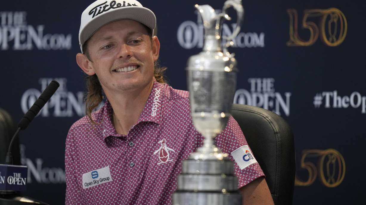 FILE - Cameron Smith, of Australia, looks at the claret jug trophy during a press conference after winning the British Open golf championship on the Old Course at St. Andrews, Scotland, Sunday July 17, 2022.
