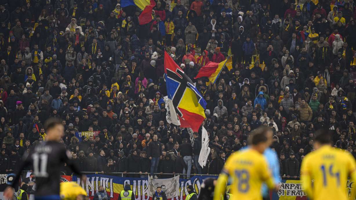 FILE - Romanian fans wave a banner in the colors of Serbia and Romania national flags during the UEFA Nations League soccer match between Romania and Kosovo was suspended at the National Arena stadium in Bucharest, Romania, Saturday, Nov. 16, 2024.