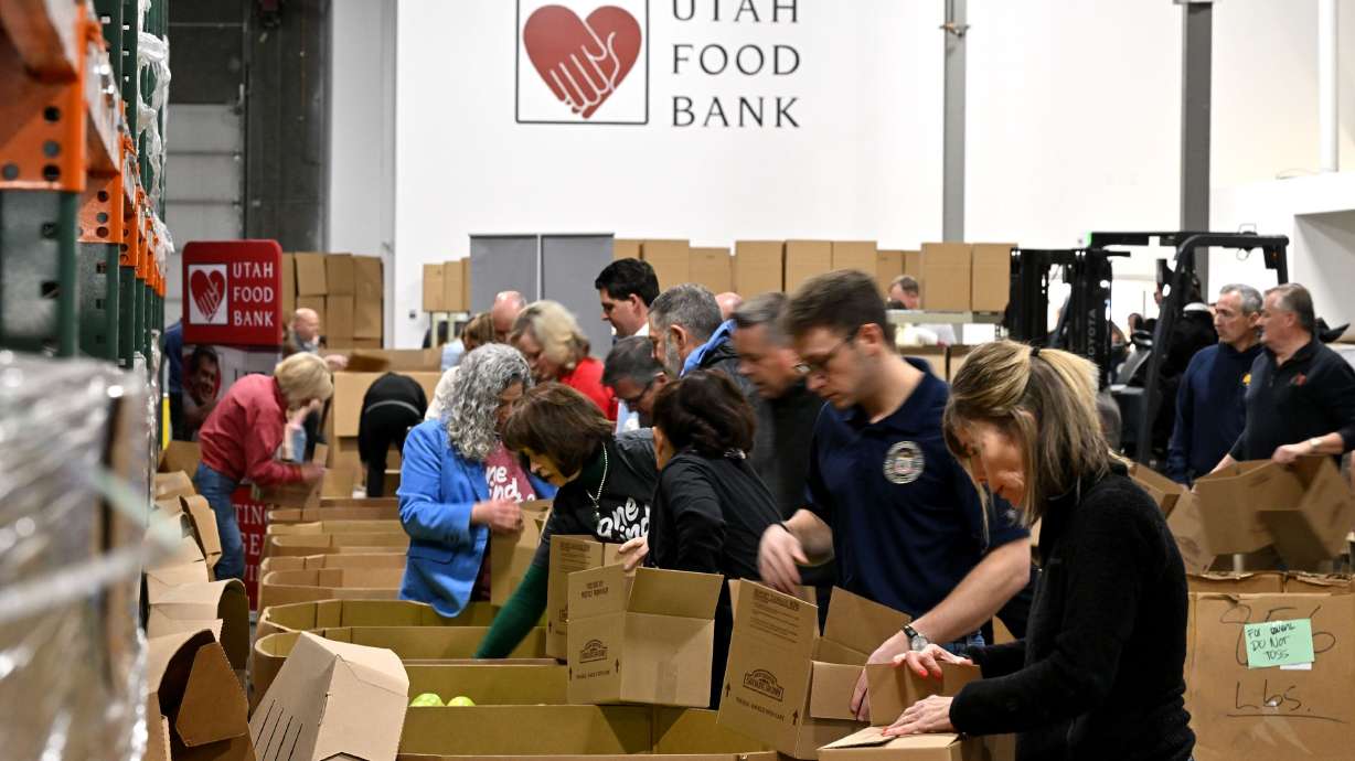 State employees and officials sort food with Gov. Spencer Cox and first lady Abby Cox at the Utah Food Bank in Salt Lake City on Jan. 7. A bill that could make it easier to donate to the food bank advanced through a House committee on Thursday.