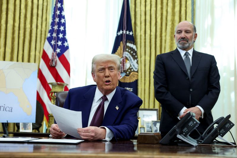 U.S. President Donald Trump speaks from the Oval Office of the White House, flanked by U.S. Commerce secretary Howard Lutnick, on the day he signs executive orders for reciprocal tariffs, in Washington on Thursday.