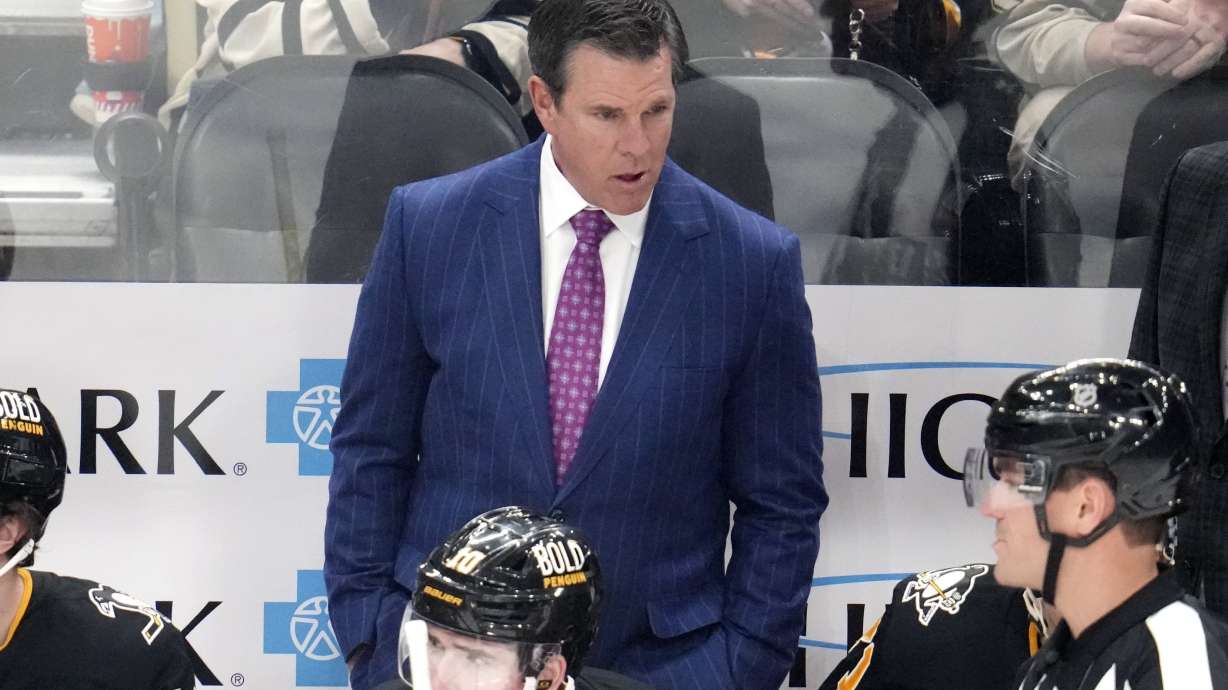 Pittsburgh Penguins head coach Mike Sullivan talks with referee Furman South, lower right, during the first period of an NHL hockey game against the Seattle Kraken in Pittsburgh, Tuesday, Jan. 14, 2025.