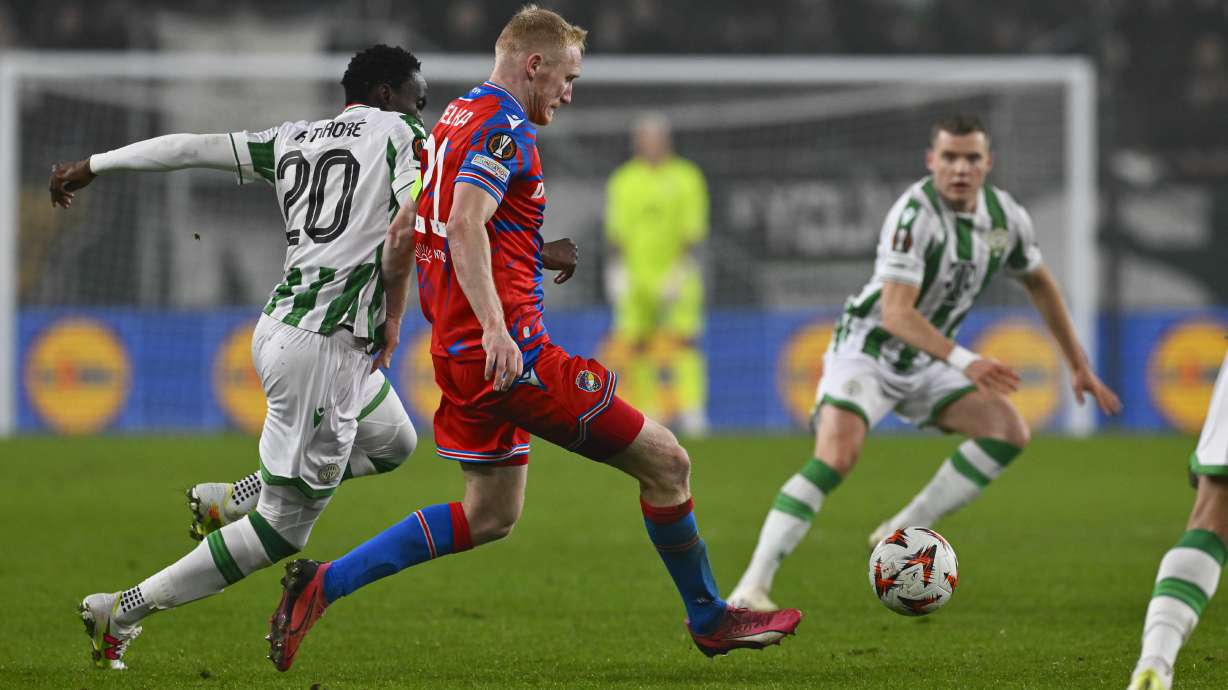 Ferencvaros' Adama Traore, left, challenges for the ball with Plzen's Vaclav Jemelka during a Europa League playoff first leg soccer match between Ferencvaros and Viktoria Plzen at the Groupama Arena stadium, in Budapest, Hungary, Thursday, Feb. 13, 2025.