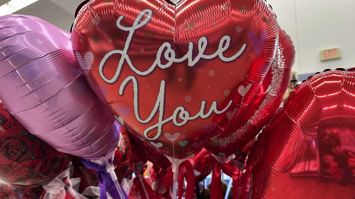 Valentine's Day balloons are displayed at a grocery store in Glenview, Ill., Monday.