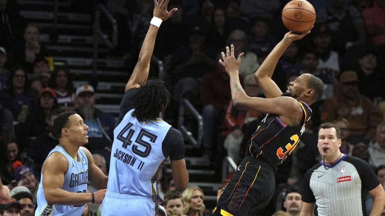 Phoenix Suns forward Kevin Durant (35) shoots over Memphis Grizzlies guard Desmond Bane and forward GG Jackson (45) during the second half of an NBA basketball game, Tuesday, Feb. 11, 2025, in Phoenix. Memphis won 119-112.