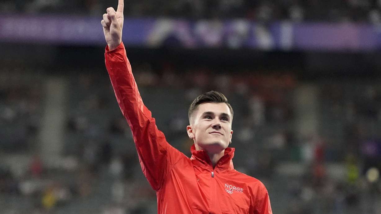 FILE - Men's 5000-meter gold medalist, Jakob Ingebrigtsen, of Norway, gestures on the podium, at the 2024 Summer Olympics, Saturday, Aug. 10, 2024, in Saint-Denis, France.