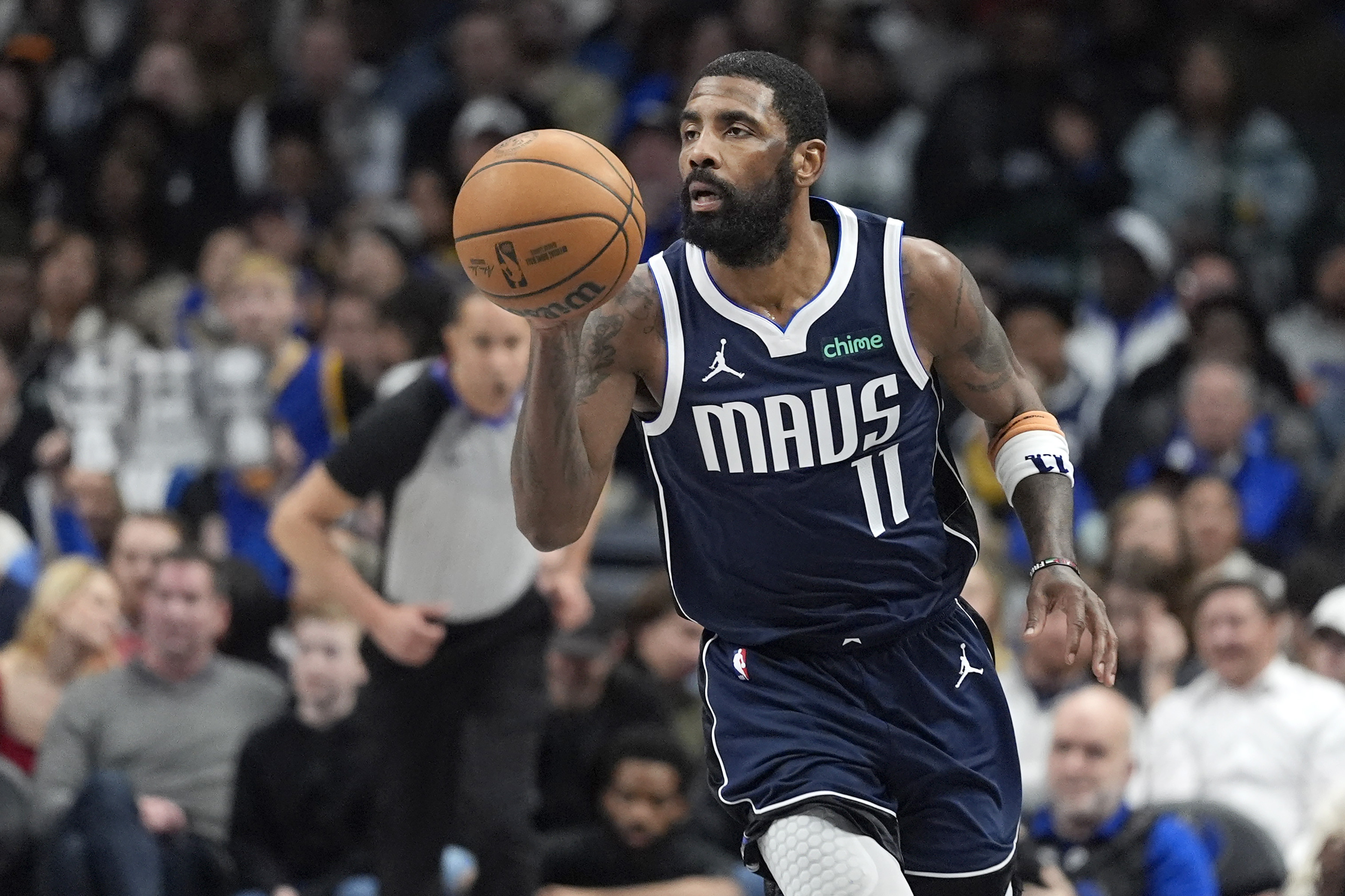 Dallas Mavericks guard Kyrie Irving dribbles the ball during the second half of an NBA basketball game against the Golden State Warriors in Dallas, Wednesday, Feb. 12, 2025.