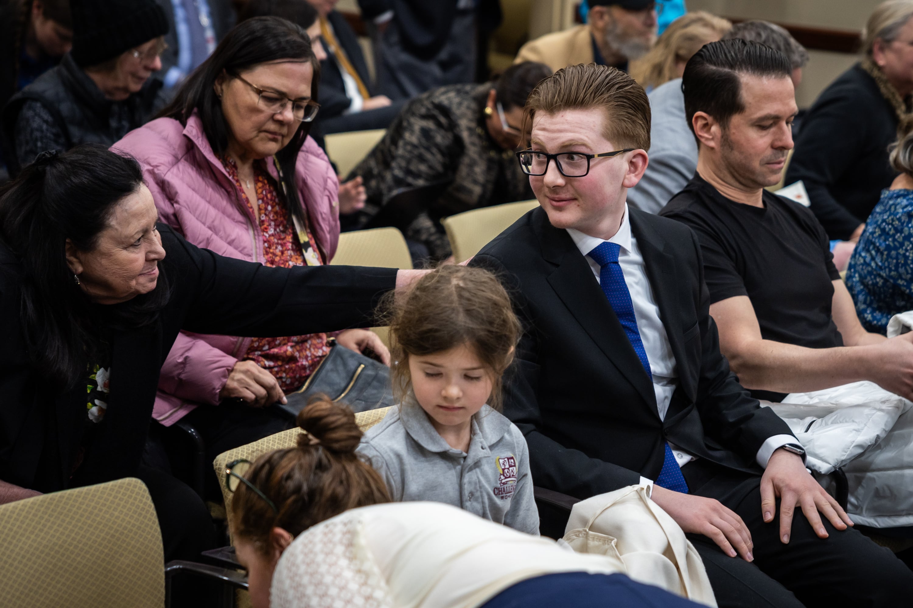 Max Widmaier, 17, right, receives a pat on the back after giving public comment in support of HB81 after Rep. Stephanie Gricius, R-Eagle Mountain, sponsored HB81 in the Senate Committee room at the State Capitol in Salt Lake City on Thursday.