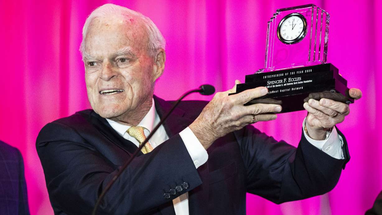 Spencer F. Eccles, CEO and chairman of the George S. and Dolores Doré Eccles Foundation, holds up the Entrepreneur of the Year award after speaking during the MountainWest Capital Network’s annual award luncheon held at the Hyatt Regency Salt Lake City in Salt Lake City on Thursday.
