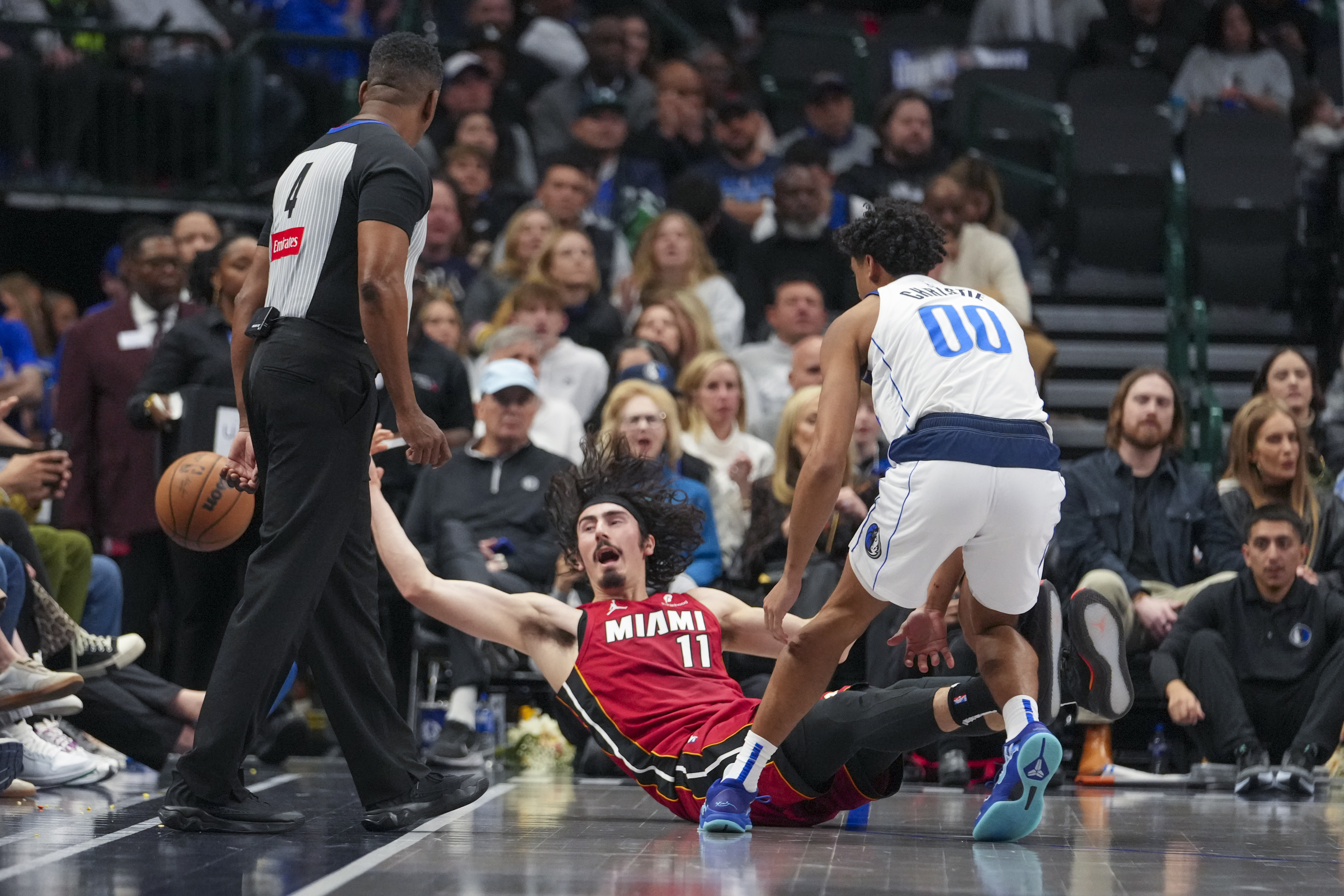 Miami Heat guard Jaime Jaquez Jr. (11) tries to keep the ball in bounds while being challenged by Dallas Mavericks guard Max Christie (00) during the first half of an NBA basketball game Thursday, Feb. 13, 2025, in Dallas.