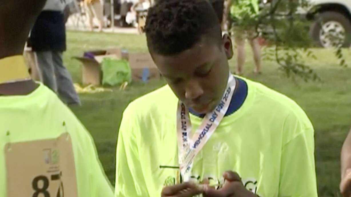 Ralph Yarl looks at a badge that he received after walking at a brain injury awareness event, May 29, 2023, in Kansas City, Mo.