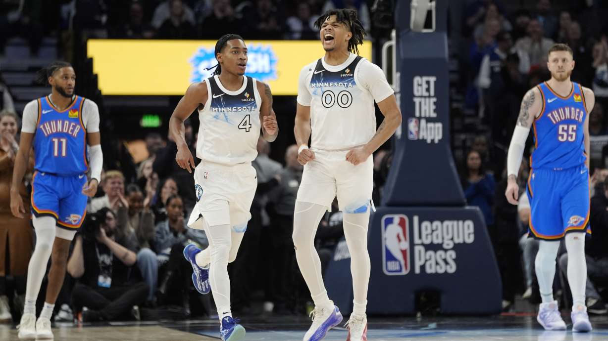 Minnesota Timberwolves guard Terrence Shannon Jr. (00) celebrates after a shot made by guard Rob Dillingham (4) during the second half of an NBA basketball game against the Oklahoma City Thunder, Thursday, Feb. 13, 2025, in Minneapolis.