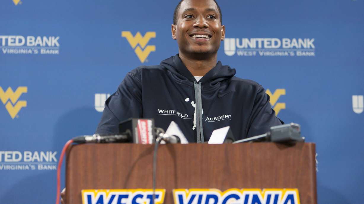 FILE - Former West Virginia quarterback Pat White speaks to the media during West Virginia University football Pro Day, in Morgantown, W.Va., on Thursday, March 14, 2013.