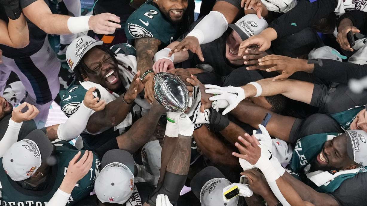 Philadelphia Eagles players celebrate with the Vince Lombardi Trophy after the Eagles won the NFL Super Bowl 59 football game against the Kansas City Chiefs, Sunday, Feb. 9, 2025, in New Orleans.