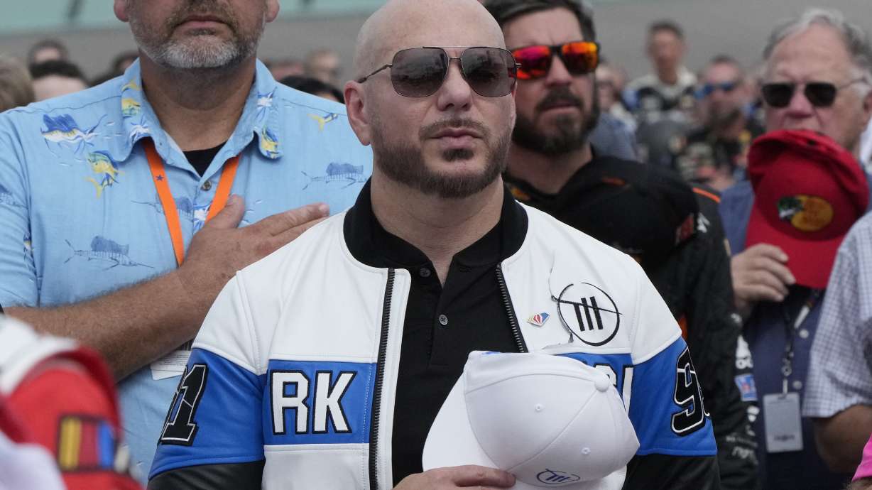 FILE - Singer, songwriter Pitbull stands during the singing of the national anthem before the start of the NASCAR Cup Series auto race at Homestead-Miami Speedway, Sunday, Oct. 22, 2023 in Homestead, Fla.