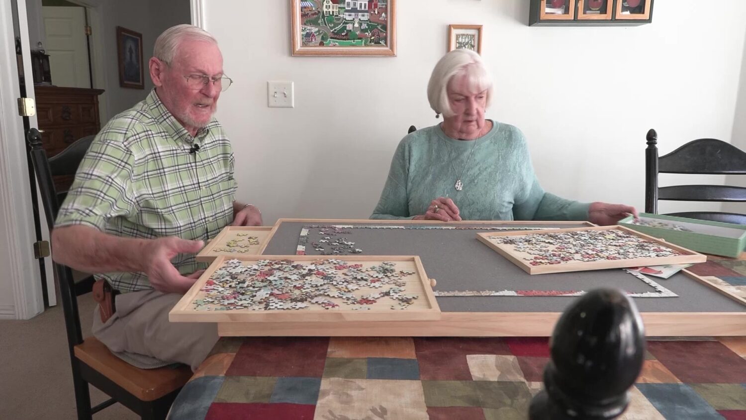 Jim and LaNae Brewster solving a jigsaw puzzle in their home.