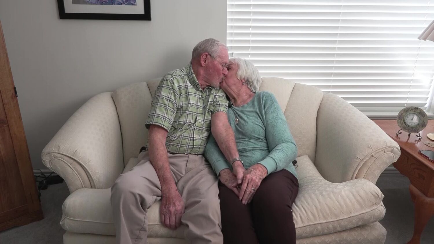 The happy couple sharing a kiss.