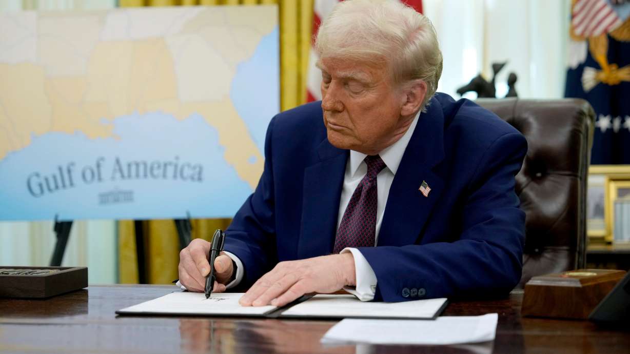 President Donald Trump signs an executive order in the Oval Office of the White House on Thursday.