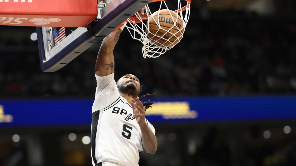 San Antonio Spurs guard Stephon Castle dunks during the first half of an NBA basketball game against the Washington Wizards, Monday, Feb. 10, 2025, in Washington.