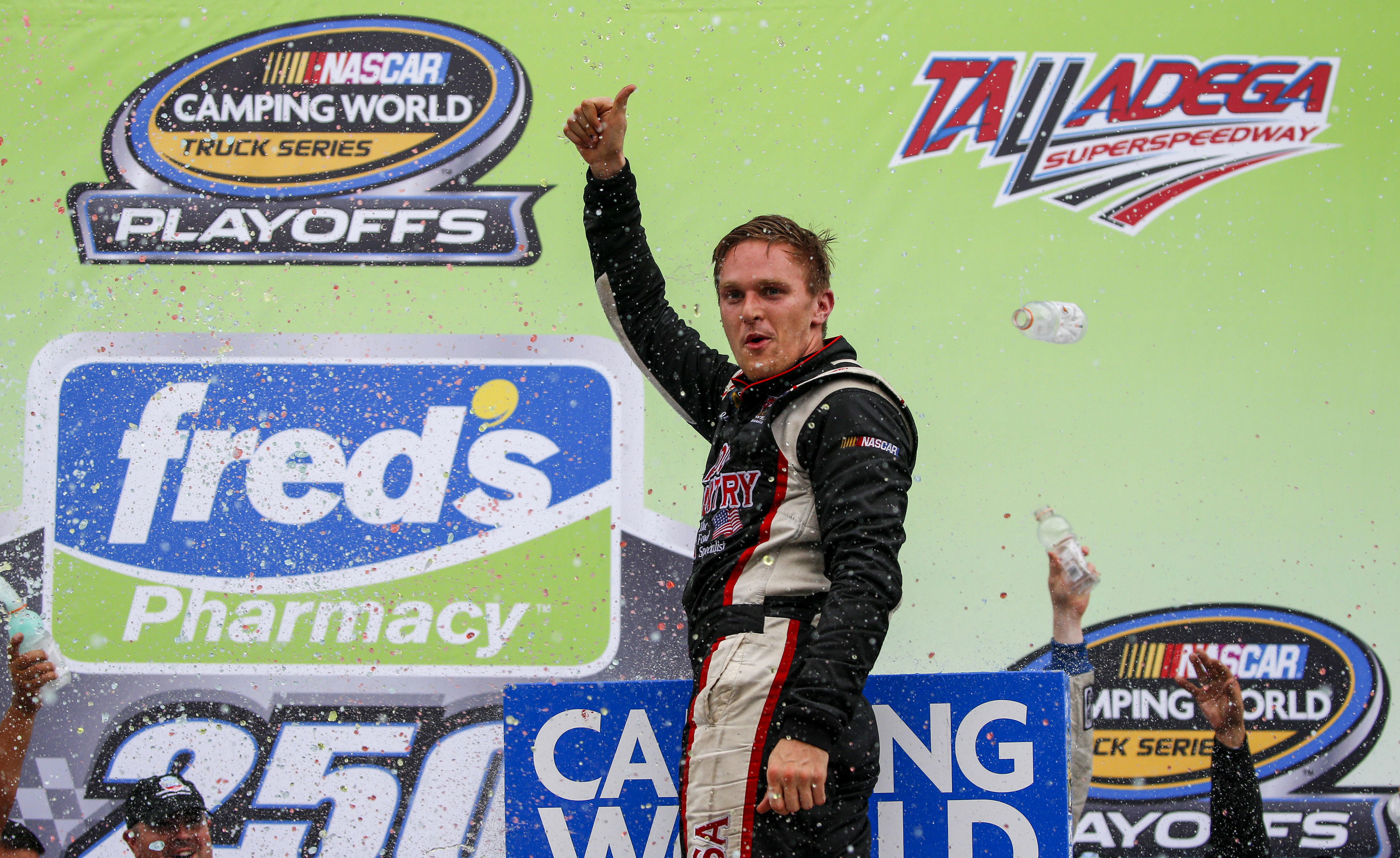FILE - Parker Kligerman (75) celebrates in Victory Lane after winning the Fred's 250 Camping World Truck Series race at Talladega Superspeedway, Saturday, Oct. 14, 2017, in Talladega, Ala.