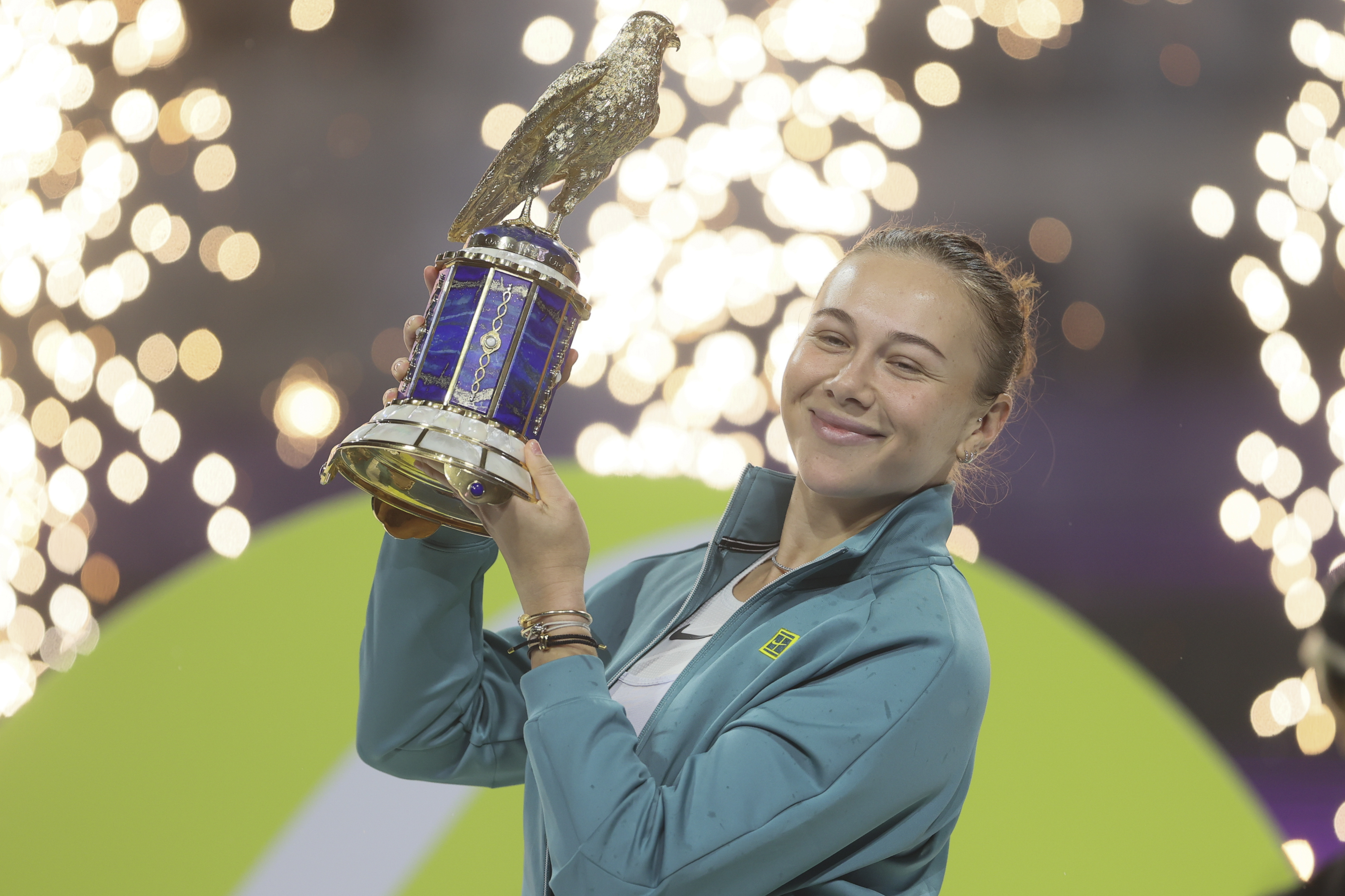 Amanda Anisimova of the United States holds the trophy after winning the Qatar Open tennis tournament in Doha, Qatar, on Saturday, Feb. 15, 2025.