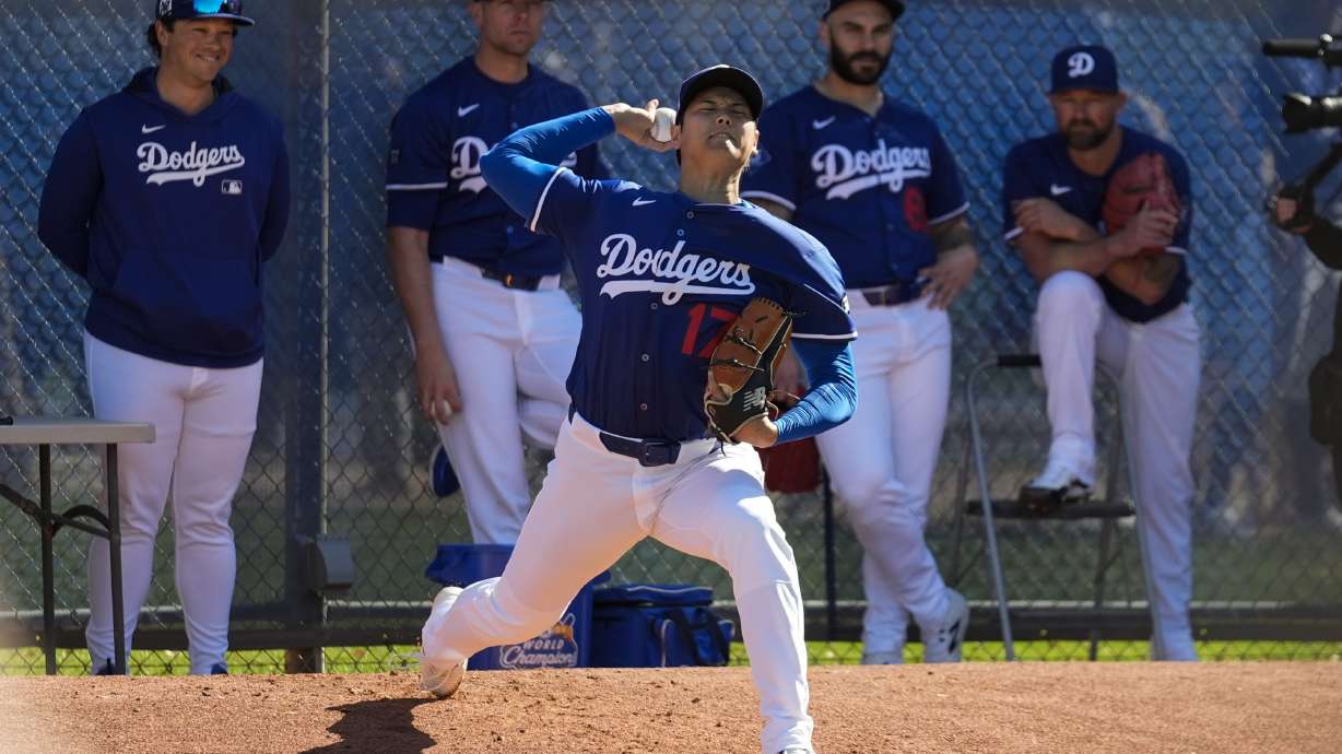 Los Angeles Dodgers two-way player Shohei Ohtani (17) works out during spring training baseball practice, Saturday, Feb. 15, 2025, in Phoenix.