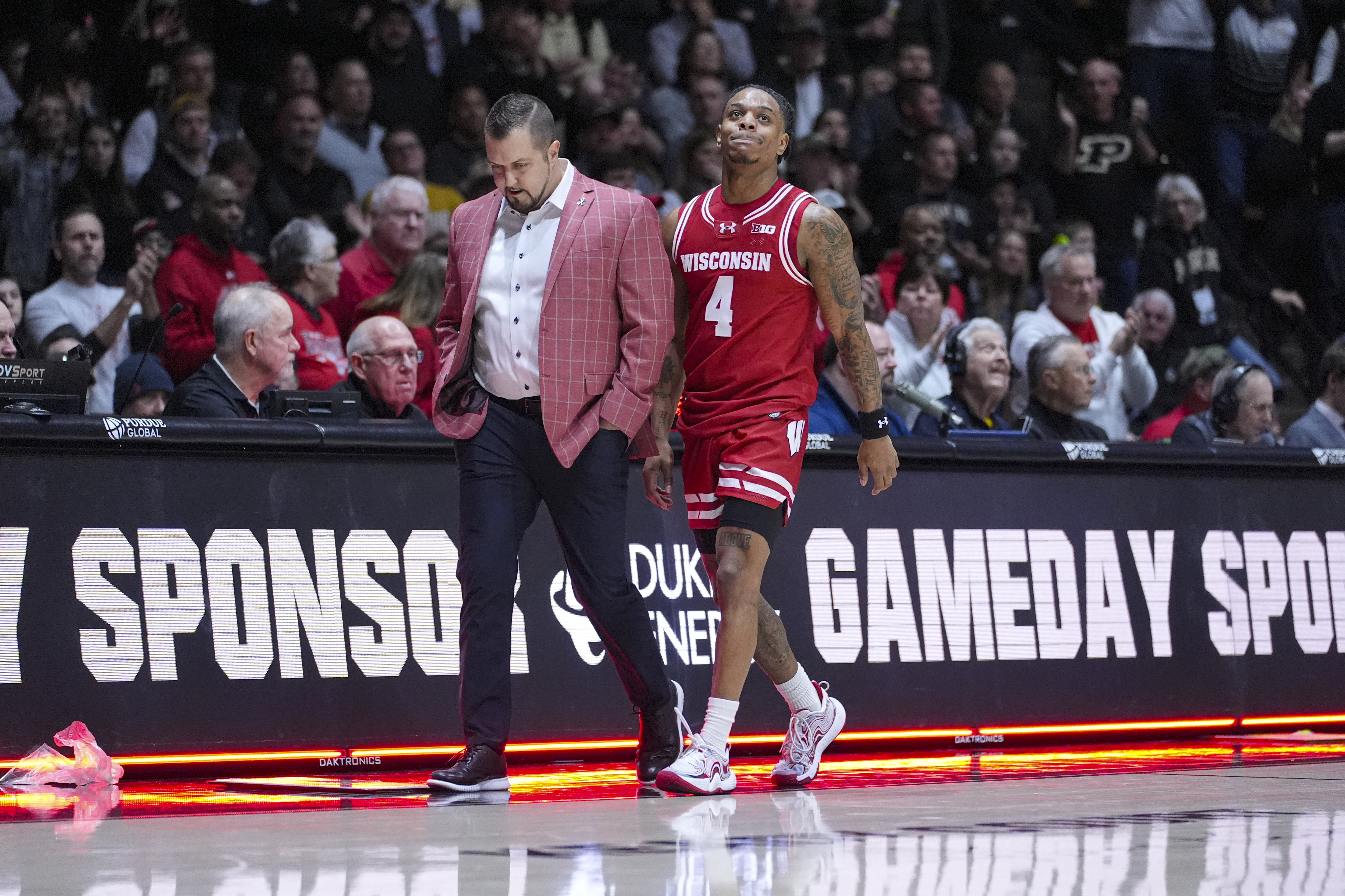 Wisconsin guard Kamari McGee (4) is escorted off the court after being ejected in the first half of an NCAA college basketball game against Purdue in West Lafayette, Ind., Saturday, Feb. 15, 2025.