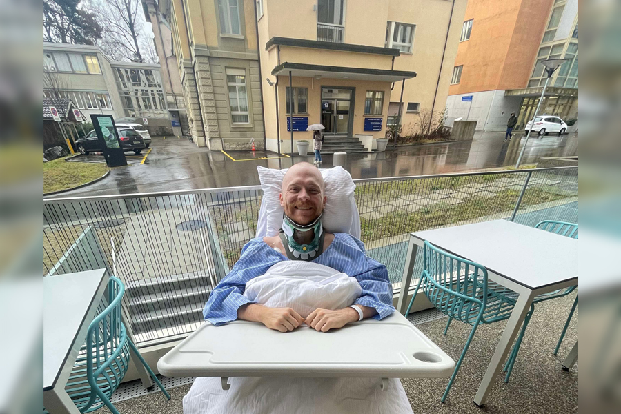 Justin Holman smiles from his hospital bed in Bern, Switzerland.