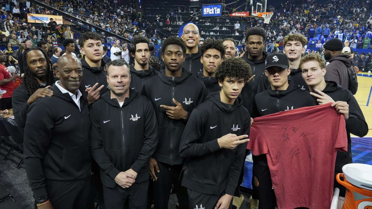 Former Golden State Warriors and Sacramento Kings coach Keith Smart, second from left, and his new team from Utah Prep Academy in Hurricane, Utah, are photographed during NBA All-Star Media Day, Saturday, Feb. 15, 2025, in Oakland, Calif.