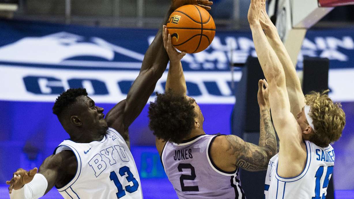 Brigham Young center Keba Keita (13) and wing Richie Saunders (15) both block a shot by Kansas State Wildcats guard Max Jones (2) during a game between BYU and the Kansas State Wildcats at the Marriott Center on the campus of BYU in Provo on Saturday, Feb. 15, 2025.